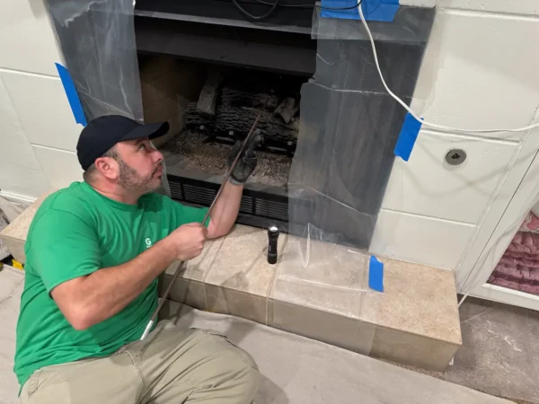 Technician cleaning chimney chute