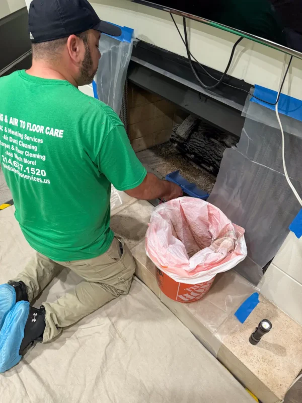 Technician removing chimney ash